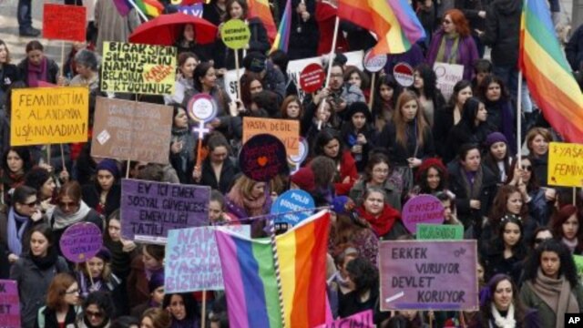 Women shout slogans and hold banners as they march through central Ankara to commemorate International Women's Day, Turkey, March 8, 2012.