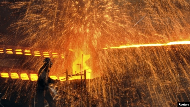A Chinese laborer works at a steel factory in Dalian, Liaoning province, December 4, 2012. 