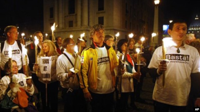 Demonstrators against the Vatican's handling of priest sex abuse cases, hold candles during a protest near St. Peter's square, Sunday, Oct. 31, 2010.