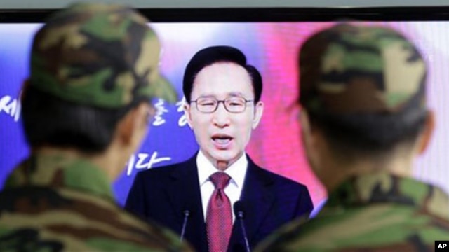 South Korean soldiers watch South Korean President Lee Myung-bak speaking to the nation during his New Year's speech,  Jan. 3, 2011.