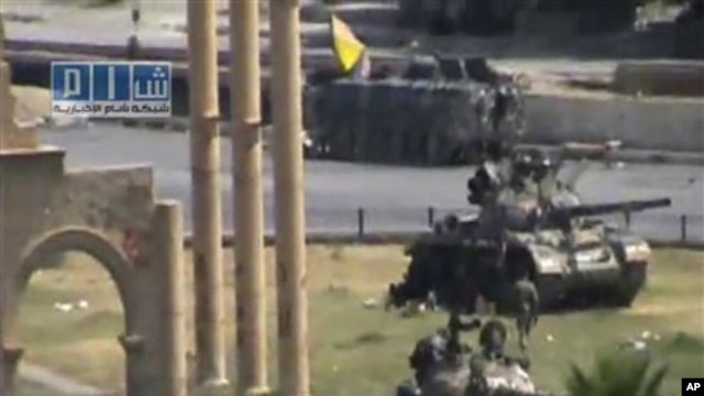 In this image made from amateur video released by the so-called Shams News Network, a loosely organized anti-Assad group and accessed via The Associated Press Television News on Aug. 1, 2011, military armored vehicles are seen in the central city of Hama,
