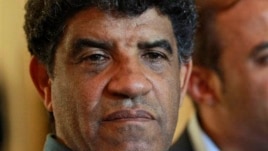 Former Libyan intelligence chief Abdullah al-Senussi, shown here Aug. 21, 2011, speaking with reporters in Tripoli, Libya.