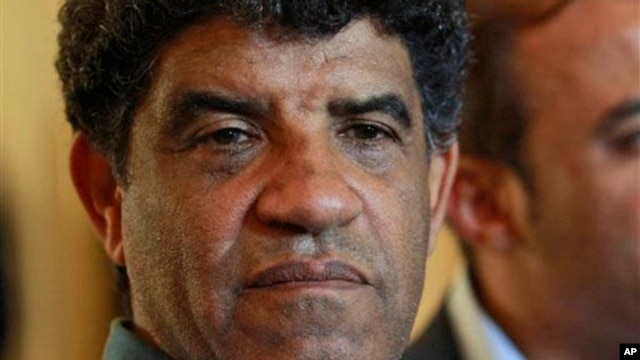 Former Libyan intelligence chief Abdullah al-Senussi, shown here Aug. 21, 2011, speaking with reporters in Tripoli, Libya.