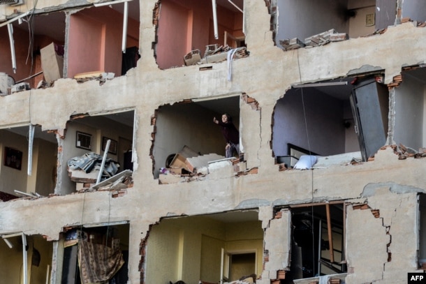 A woman reacts in her damaged apartment on the explosion site, Nov. 4, 2016 after a strong blast in the southeastern Turkish city of Diyarbakir.