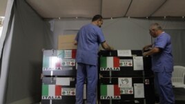 The Italian Medical crew opens the medical supplies boxes at the Italian Field Hospital for Syrian refugees, which was established in al Mafraq city, Jordan, July 10, 2012.