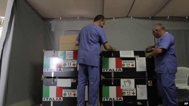 The Italian Medical crew opens the medical supplies boxes at the Italian Field Hospital for Syrian refugees, which was established in al Mafraq city, Jordan, July 10, 2012.