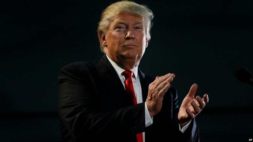 Republican presidential candidate Donald Trump applauds during a rally, Thursday, June 2, 2016.