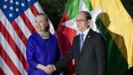 U.S. Secretary of State Hillary Rodham Clinton, left, and Burma President Thein Sein shake hands before a meetingin Siem Reap, Cambodia, July 13, 2012.