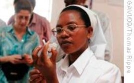 A Rwandan nurse prepares a dose of Prevenar, a pneumococcal vaccine. The South African government has also made the vaccine part of its national immunization program.