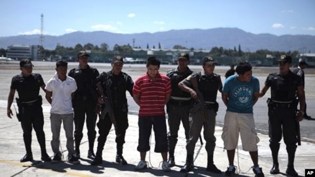 Guatemalan police escort suspected members of the Zetas drug cartel at the air force base in Guatemala City, March 8, 2012.