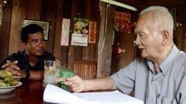 Thet Sambath, filmmaker of the 'Enemies of the People', speaking to former Khmer Rouge leader Nuon Chea. 