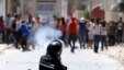 Riot officer fires teargas during clashes with supporters of Islamist group Ansar al-Sharia at Hai al Tadamon, Tunis, May 19, 2013.