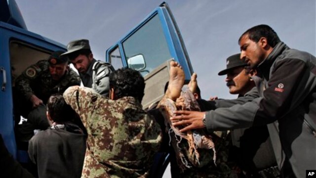 Afghan soldiers remove dead passenger from  truck after U.S. forces shot two passengers and injured another on road between Kabul and Bagram, March 11, 2013.
