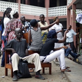 Voters wait for election material to arrive at a polling station in Kinshasa, Congo, November 28, 2011