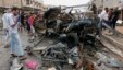 Civilians gather at the scene of a car bomb attack in Kamaliyah neighborhood, a predominantly Shiite area of eastern Baghdad, Iraq, Monday, May 20, 2013.