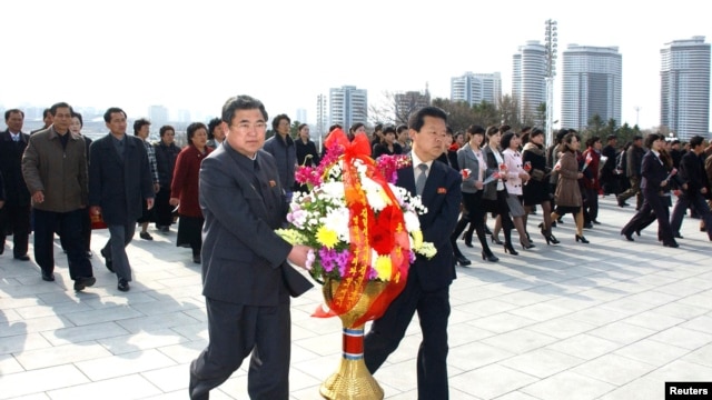 Dân Bắc Triều Tiên đặt vòng hoa trước tượng của Chủ tịch Vĩnh cửu Kim Il Sung và cố lãnh tụ Kim Jong-Il tại Mansudae, Bình Nhưỡng.