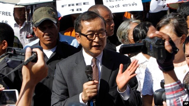 Opposition leader of Cambodia National Rescue Party Sam Rainsy, center, delivers a speech during a gathering to mark Human Rights Day, in front of National Assembly, in Phnom Penh, Cambodia, file photo. (AP Photo/Heng Sinith)