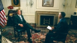 Vincent Makori interviews U.S. President George W. Bush at the White House in 2003. Makori did the interview before joining the president on a five-nation African trip.