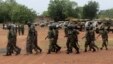 Soldiers from Lagos, part of an expected 1,000 reinforcements sent to Adamawa state to fight Boko Haram Islamists, walk near trucks as they arrive with the 23rd Armoured Brigade in Yola May 20, 2013. 