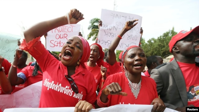 Nigerians take part in a protest demanding for the release of secondary school girls abducted from the remote village of Chibok, in Asokoro district in Abuja, Nigeria, May 13, 2014. 