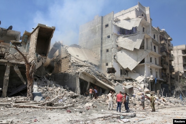 Men inspect a damaged building after airstrikes on a rebel-held neighborhood of Aleppo, Syria, Aug. 27, 2016.