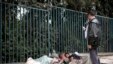 An Ethiopian man uses his mobile phone to take a picture of street children sleeping on a street of Addis Ababa in Ethiopia, (File photo).