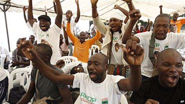 Supporters of opposition leader Alassane Ouattara, make their feelings known, as they sing at an event at a hotel in Abidjan, Ivory Coast, 30 Dec 2010