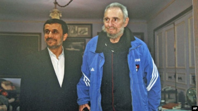 Iran's President Mahmoud Ahmadinejad (L) stands with former Cuban leader Fidel Castro, in Cuba, January 12, 2012.