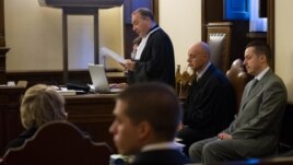 Pope Benedict's former butler Paolo Gabriele (R), accused of stealing and leaking the pontiff's personal papers, sits at the start of his trial at the Vatican September 29, 2012.