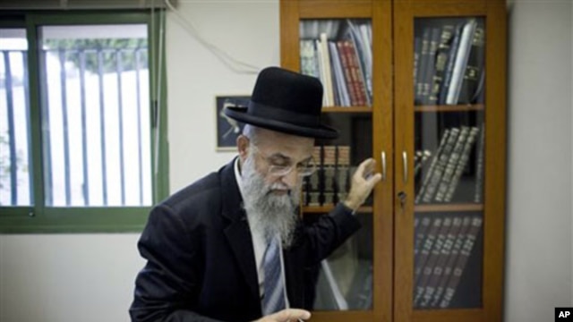 Israeli rabbi Mordechai Nagari, one of the signatories of the controversial ruling, poses for a photo in his office in the Jewish West Bank settlement of Maaleh Adumim near Jerusalem, 07 Dec 2010