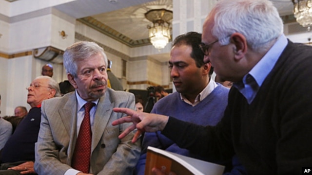 Nofal Al Dawalibi (l), son of former Syrian PM, speaks to journalists before a news conference to unveil a plan to form Syrian interim government in Paris, France, April 26, 2012. 