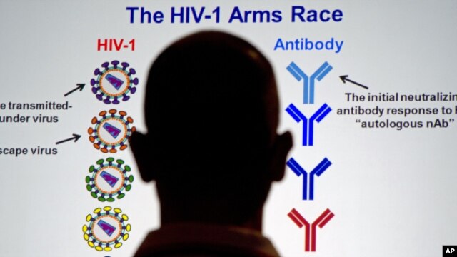 A member of the audience looks at slides projected on huge video screens during the XIX International AIDS Conference in Washington, July 25, 2012. 