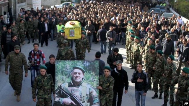 Hezbollah fighters, center, carry the coffin of their commander Ali Bazzi who was killed in Syria,Dec. 9, 2013.  (AP Photo/Mohammed Zaatari)