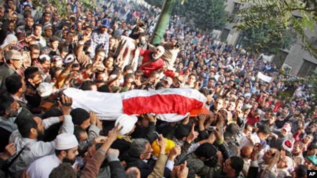 Egyptians carry the body of a protester killed during recent clashes in Tahrir Square, Cairo, December 19, 2011