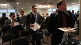 Veterans wait to speak to a representative from Securitas during a job fair at Yankee Stadium in the Bronx borough of New York, September 28, 2012.