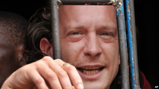 David Cecil, the British producer of the play "The River and the Mountain" concerning the condition of Uganda's gays, stands in a court cell in the capital Kampala, Uganda, September 13, 2012.