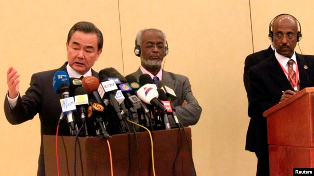 Chinese Foreign Minister Wang Yi (L), Tedros Adhanom, former Ethiopia's Foreign Minister, and Chair of the IGAD Council of Ministers and Sudan's Foreign Minister Ali Karti (C) after a meeting to support the Intergovernmental Authority on Development (IGAD)-led South Sudan peace process in Khartoum January 12, 2015.
