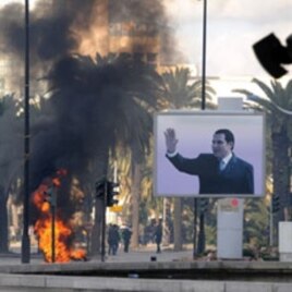 Smoke rises from fire left after clashes between security forces and demonstrators in Tunis, 14 Jan 2011