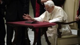 Pope Benedict XVI watches a tablet at the Vatican, in Rome, December 12, 2012.