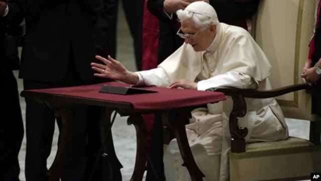 Pope Benedict XVI watches a tablet at the Vatican, in Rome, December 12, 2012.
