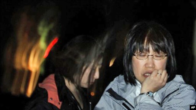 A Japanese woman reacts in Ishinomaki, Iwate Prefecture, northern Japan, after a 7.1 magnitude earthquake struck offshore, late Thursday, April 7, 2011.