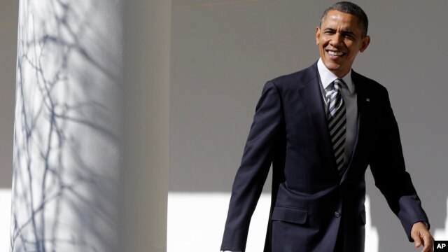 President Barack Obama looks towards reporters as he walks down the West Wing Colonnade of the White House on February 12, 2013, ahead of his State of the Union speech on Capitol Hill. 