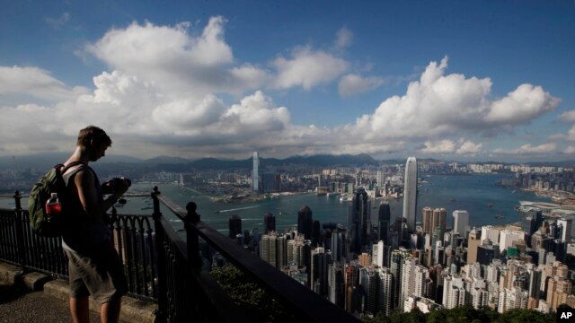 A tourist takes a picture from the Victoria Peak in Hong Kong