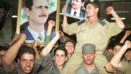 Syrian army soldiers waved portraits of Bashar al-Assad in Damascus in July, 2000, when he became president. 