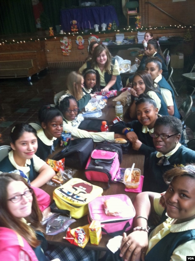 Students at Saint Camillus Catholic school enjoy lunch together in the school building damaged after Superstorm Sandy. (VOA/A. Phillips)