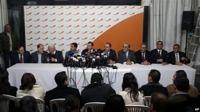 From left: Lebanese Ministers Ali Abdallah, Mohammed Fneish, Abraham Dedeyan, Hussein Hajj Hassan, Jibran Bassil, Mohammed Jawad Khalife, Fady Abboud, Charbel Nahhas, Youssef Saade and Ali Shami hold a press conference to announce their resignation in the