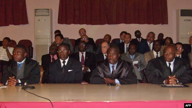 British mercenary Simon Mann's lawyer Juan Pablo Nvo (2ndR), lawyer of mercenaries of Equatorial Guinea Fabian Nsue Nguema (R) and two unidentified defence lawyers listen to the court on July 7, 2008 at Malabo's courthouse. 