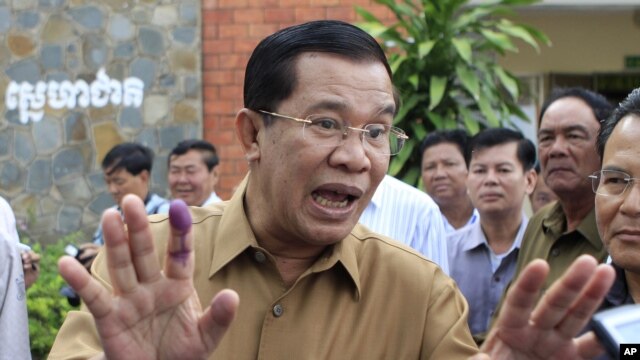 Cambodian Prime Minister Hun Sen gestures after casting his ballot in local elections at Ta Khmau town, in Kandal province.
