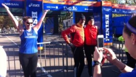 Dressed to run, people pose for photos at the finish line for the 2012 New York Marathon, Saturday, Nov. 3, 2012 in New York’s Central Park.