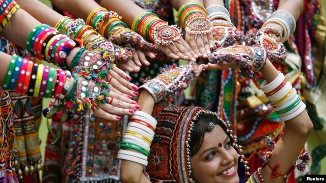 A girl dressed in traditional attire poses as she takes part in rehearsals for the "garba" dance ahead of Navratri festival in the western Indian city of Ahmedabad, Sept. 29, 2013.